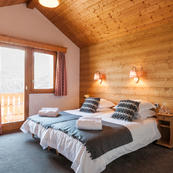 Chalet Foehn Room 1, top floor Quad room accommodates 4 guests, with door leading through to adjoining annex