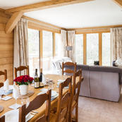 Chalet Les Sauges large picture windows offer direct access to sundeck and hot tub.