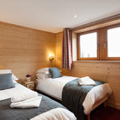 Warmly furnished bedrooms, in a contemporary alpine style