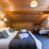 Top floor bedroom comfortably sleeps 3, 4th bed can be added if you want to go for maximum occupancy in Chalets Foehn, Covie, Charmille.