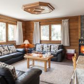 Chalet Charmille's spacious living room & views out onto hot tub.