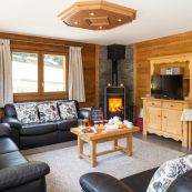 Chalet Charmille bright social living room leads to an expansive sun deck and hot tub